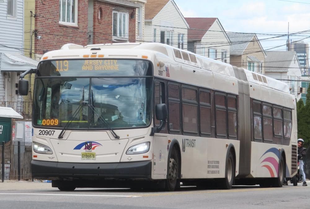 A city bus pulling up to a stop