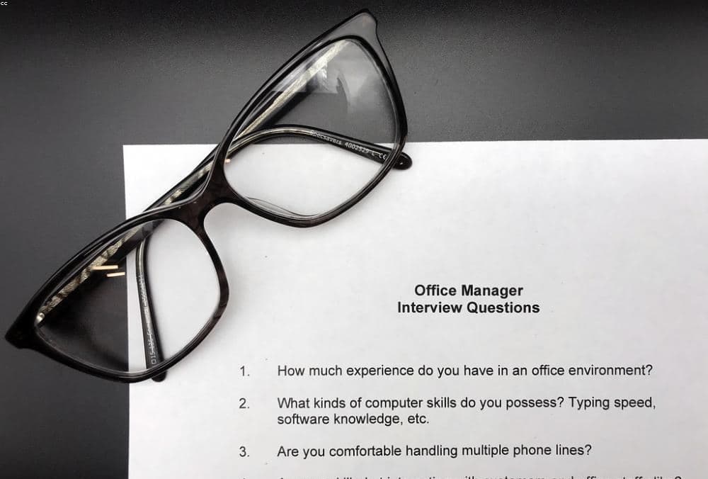 Notes and reading glasses on a desk
